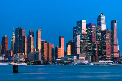 Midtown manhattan skyline showcasing the modern hudson yards and the iconic empire state building.