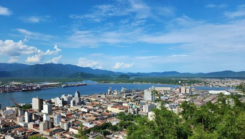 High angle view of townscape by sea against sky