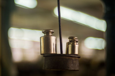 Close-up of electric lamp hanging in row