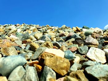 Stones on rocks against clear blue sky