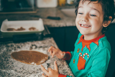 The heartwarming scene of a mother and son preparing christmas gingerbread reflects the joy