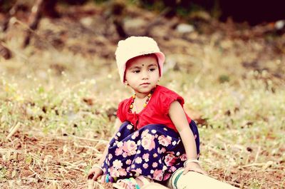 Girl sitting on field at park