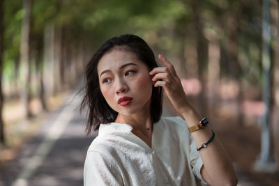 Portrait of beautiful woman against blurred background