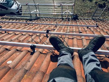 Low section of man relaxing on metal railing