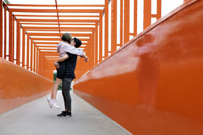 Full length side view of man standing against wall