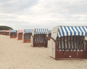 Scenic view of beach against cloudy sky