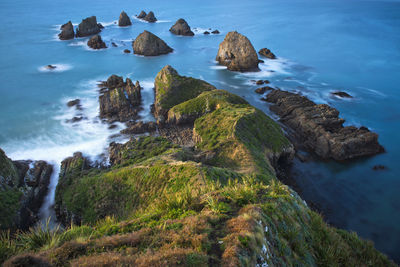 High angle view of rocks in sea against sky