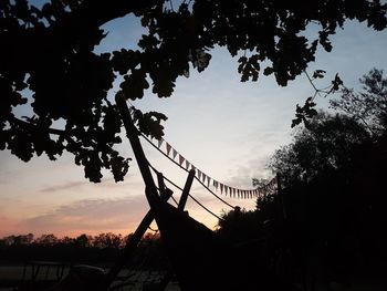 Low angle view of silhouette bridge against sky during sunset