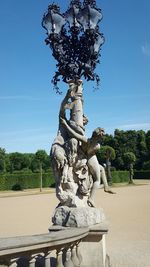 Low angle view of statue against blue sky