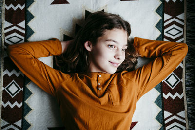 High angle portrait of baby girl lying on floor