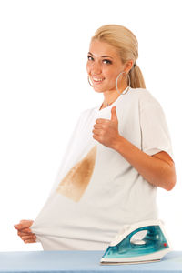 Portrait of smiling young woman against white background