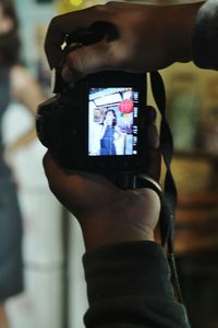 Close-up of hand holding camera