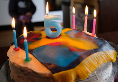 Close-up of lit candles on birthday cake