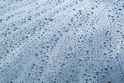 Close up rain drop on surface of car's body after passed from rainy area