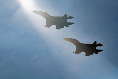 Squadron of sukhoi su30 fly by cross the sunshine, low attitude air show
