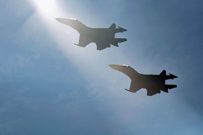 Low angle view of airplane flying against sky