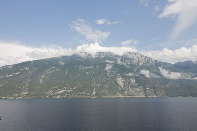 Scenic view of sea and mountains against sky