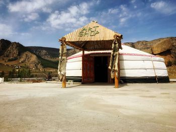 Built structure on landscape against sky