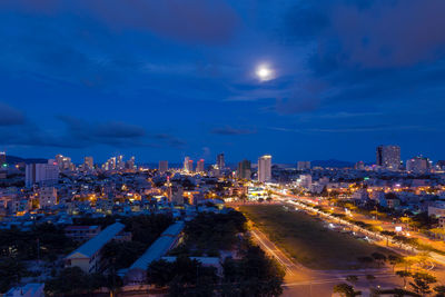 High angle view of illuminated city buildings at night