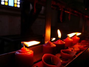 Close-up of burning candles in temple