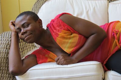 Portrait of man sitting on sofa at home