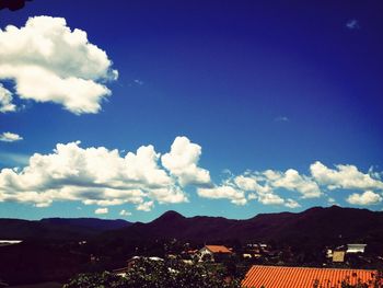 Scenic view of mountain range against cloudy sky