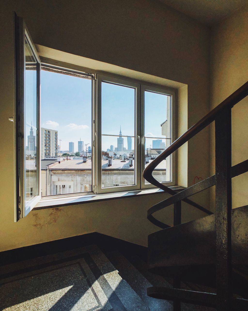 VIEW OF BUILDINGS THROUGH WINDOW