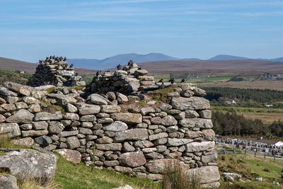 Stone wall on mountain against sky