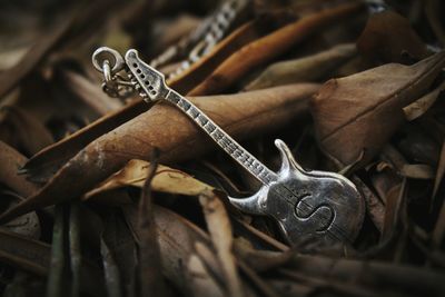 High angle view of silver guitar equipment on wood