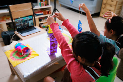 High angle view of boy playing with toys on table