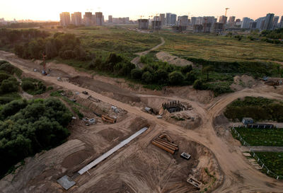 High angle view of road by cityscape against sky