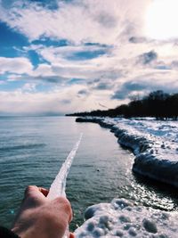 Person on sea against sky