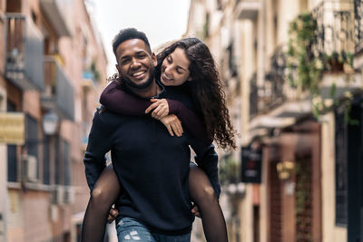 Portrait of cheerful couple walking on road