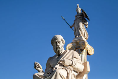 Low angle view of statue against clear blue sky