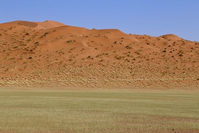 Scenic view of desert against clear sky