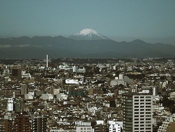 Cityscape with mountain range in background