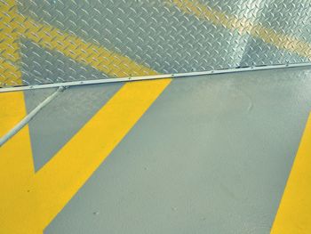 Yellow arrow symbol on zebra crossing