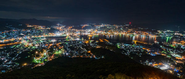 High angle view of illuminated buildings in city at night