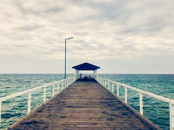 Pier over sea against sky