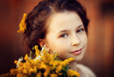 Close-up portrait of woman with red flower