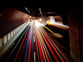 High angle view of light trails on railroad tracks at night