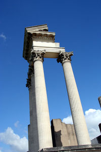 Low angle view of old ruin against blue sky