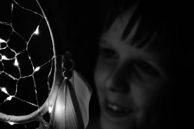 Close-up of boy holding illuminated dreamcatcher