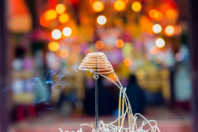 Close-up of incenses burning at temple