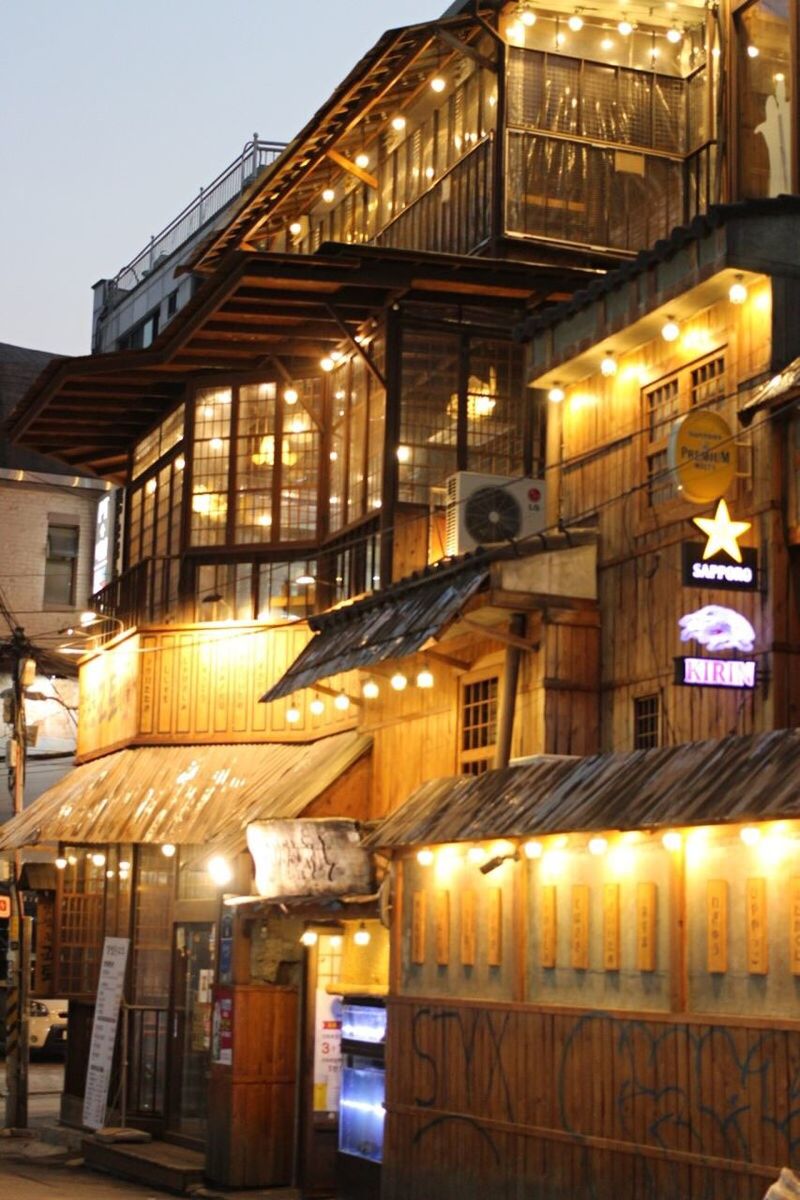 LOW ANGLE VIEW OF ILLUMINATED LANTERNS IN CITY