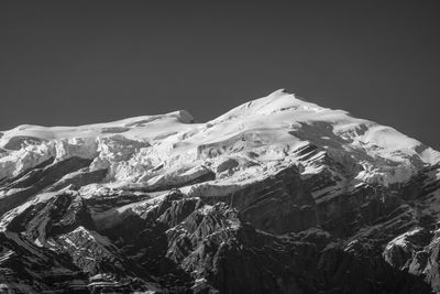 Scenic view of snowcapped mountains against clear sky