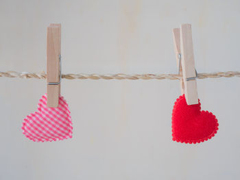 Close-up of decoration hanging on table against white background