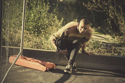 Full length of woman sitting on bench