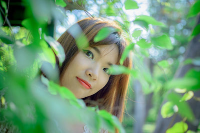 Portrait of woman with green leaves