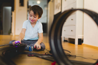 Boy playing with toy car at home